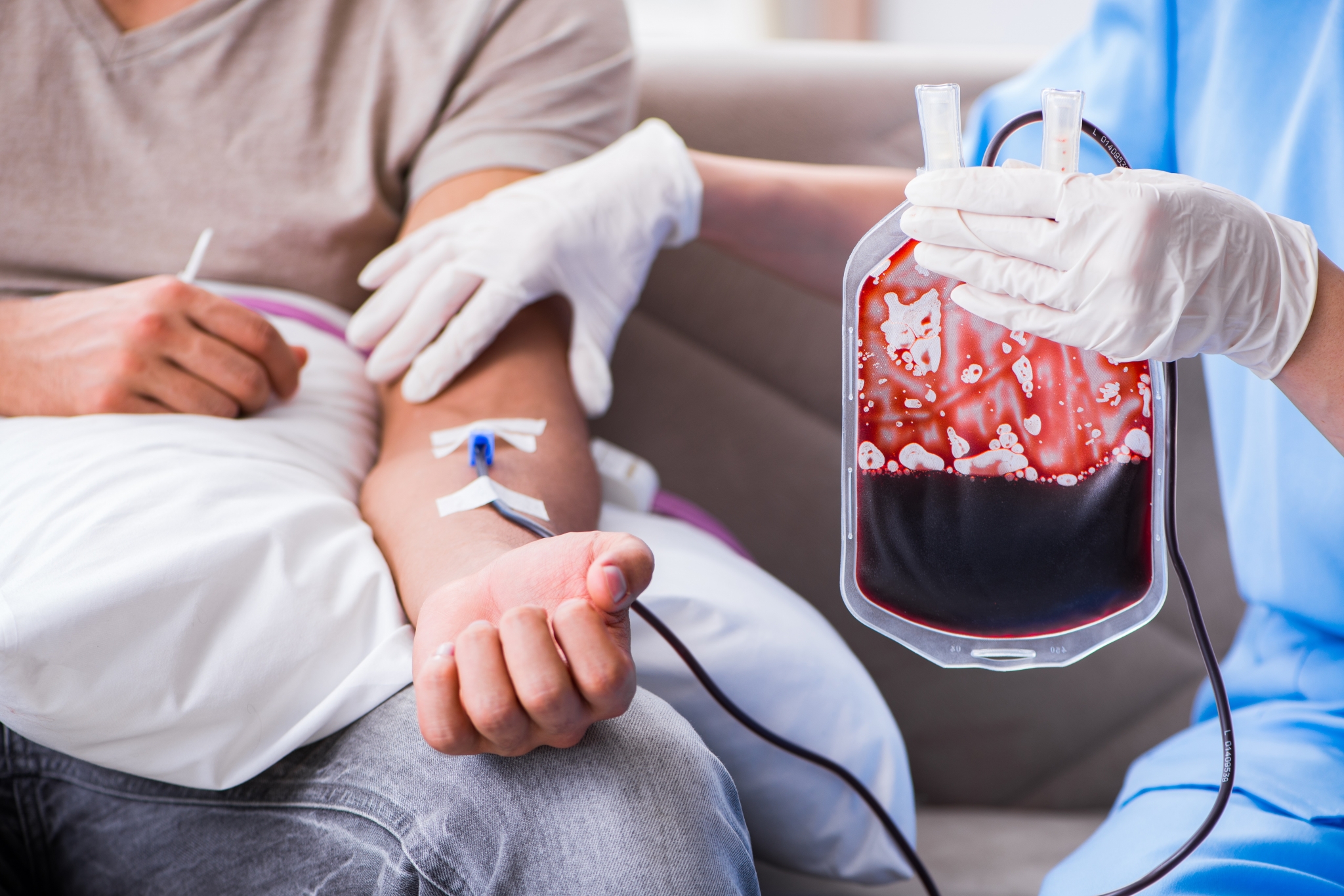 Nurse caring for a patient with a blood transfusion